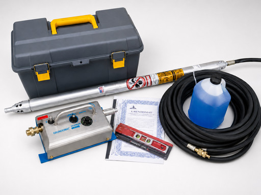 Grundomat percussive piercing tool kit with control unit, hose, fluid jug, level, manual, and carrying case
